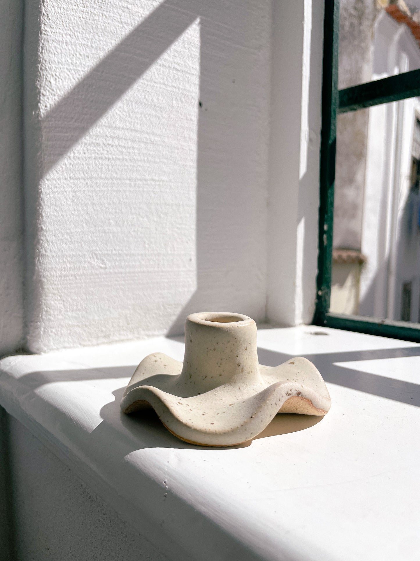 White matte candle holder with speckle effect.  Width: 10 cm.