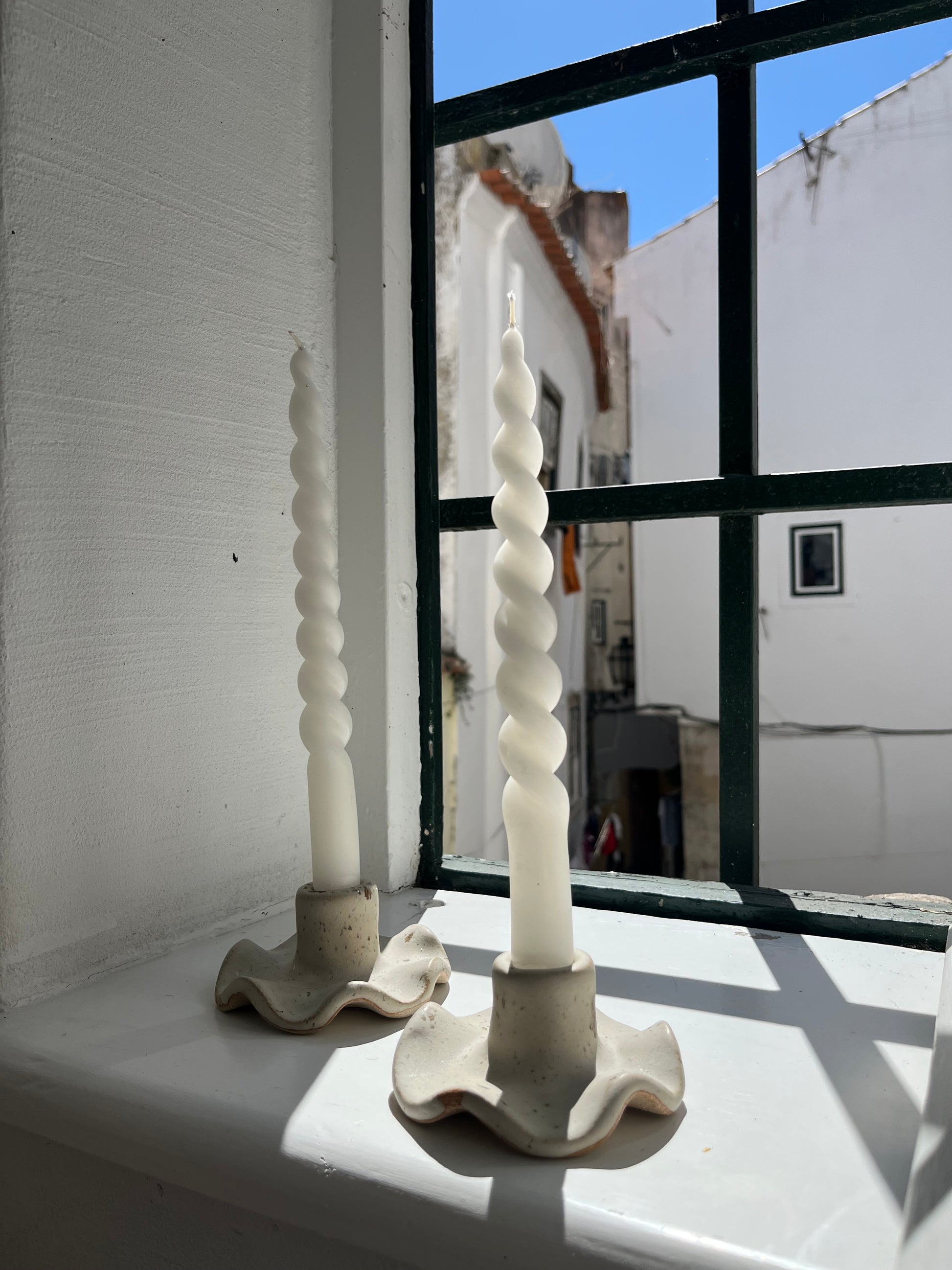 White matte candle holder with speckle effect.  Width: 10 cm.