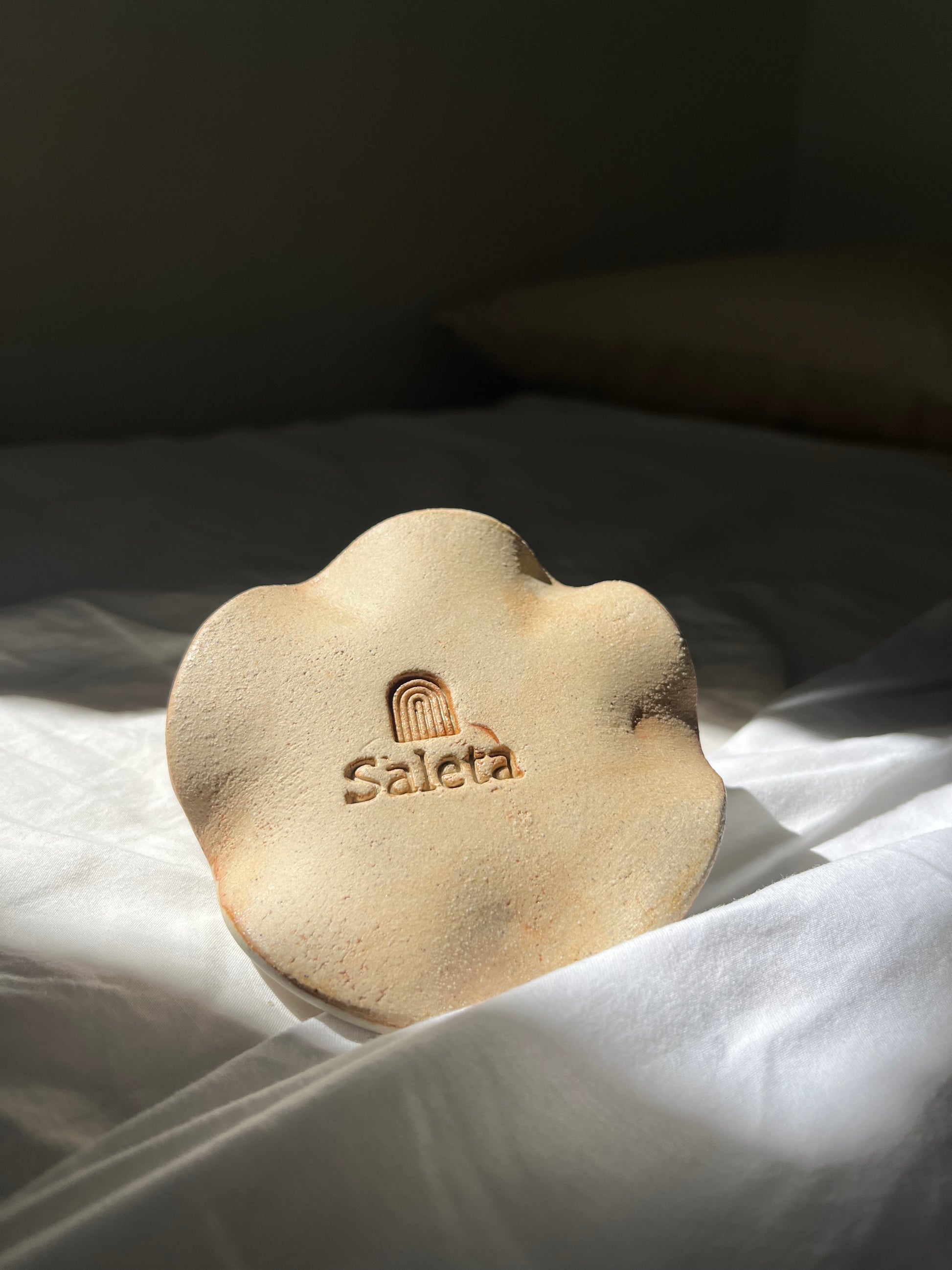 White matte candle holder with speckle effect.  Width: 10 cm.