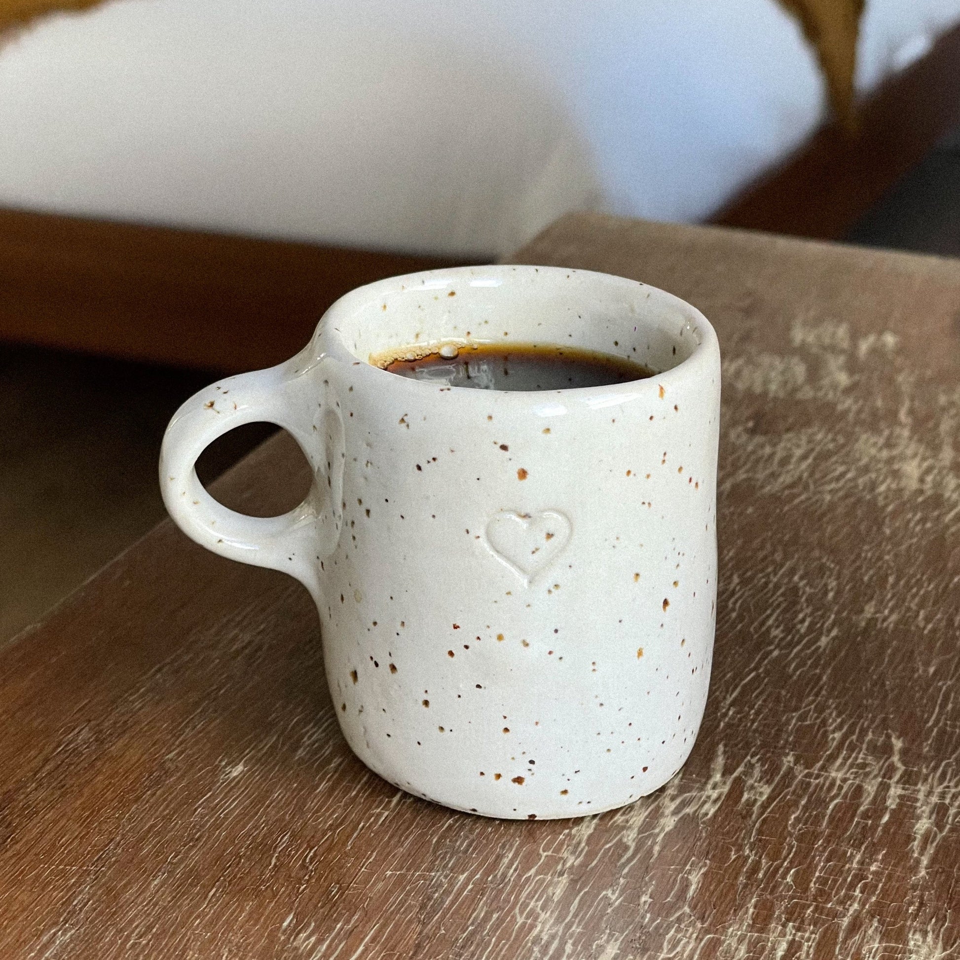 Sip in style with our handmade ceramic espresso cup featuring a charming heart stamp and a unique sparkled effect. Elevate your coffee moment with this special touch of flair